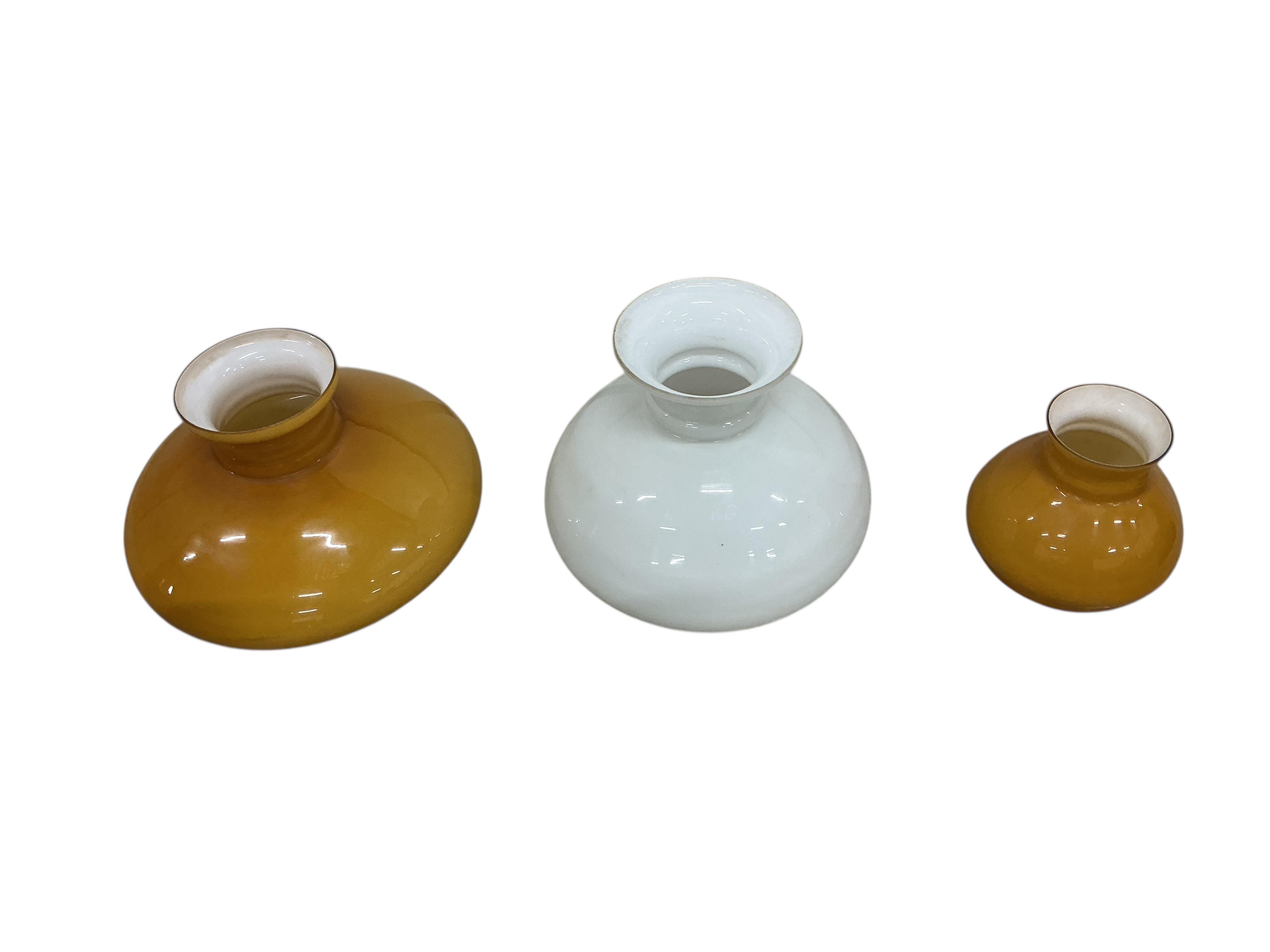 A pair of late Victorian brass wall fitting gas lamps with odd shades (converted), and another electric wall light